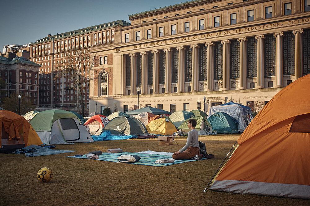 A protestor meditates early Monday morning inside the pro-Palestinian encampment on Columbia University campus.