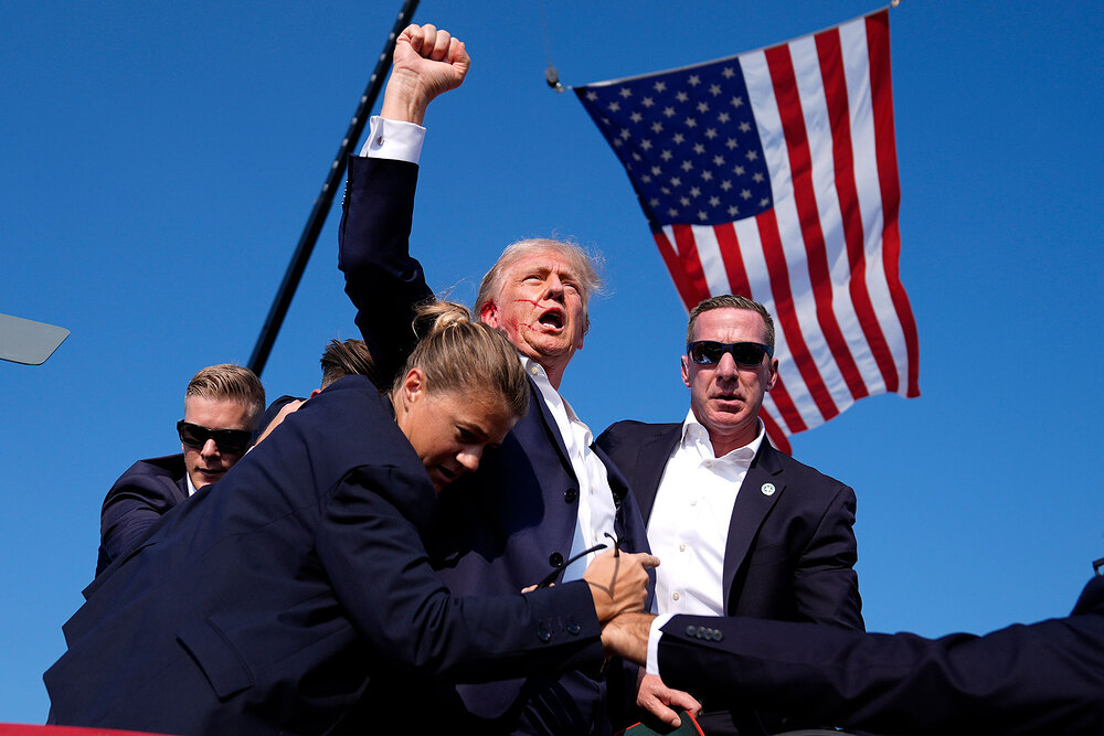 APTOPIX Election 2024 Trump Donald Trump is surrounded by U.S. Secret Service agents at a campaign rally after an assassination attempt in Butler, Pa., on July 13.