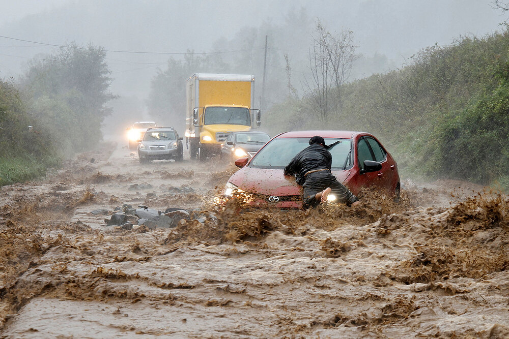A resident helps free a stranded car as Tropical Storm Helene strikes Boone, North Carolina A resident helps free a stranded car as Tropical Storm Helene strikes Boone, North Carolina