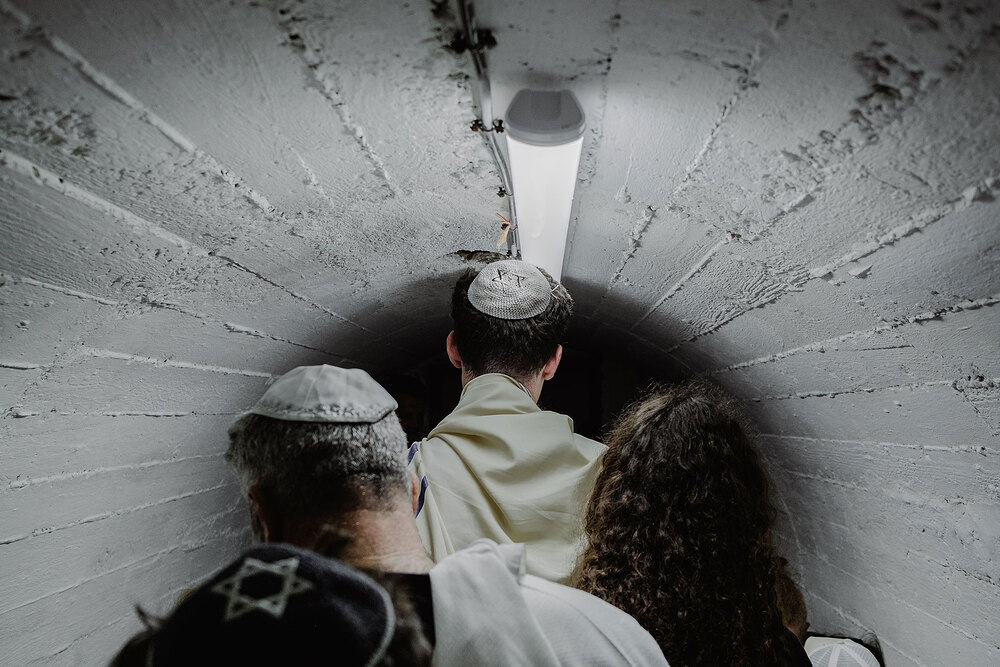 An Israeli family gathers during their son’s bar mitzvah in an underground bomb shelter near Nahariya in northern Israel